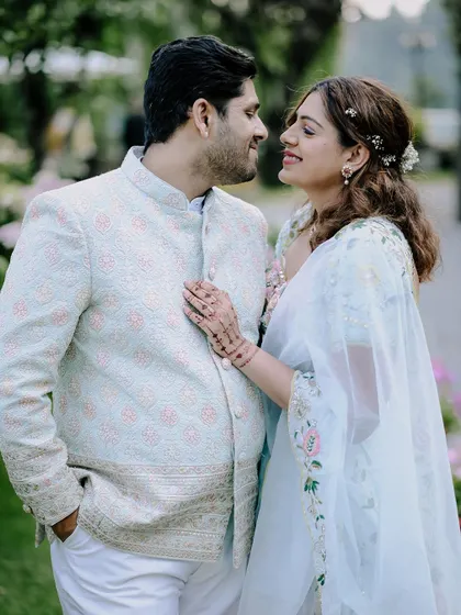 An intimate close-up of the couple, showcasing their pastel-themed engagement outfits.