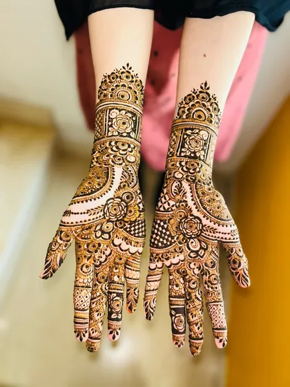 A beautiful non-bridal design with a mix of floral and geometric patterns. The cuff at the wrist is particularly detailed.