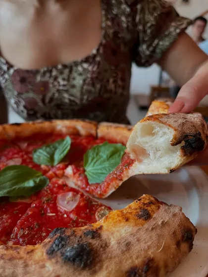 Simplicity at its best. A slice of our Marinara pizza, showing off the light and airy crust.