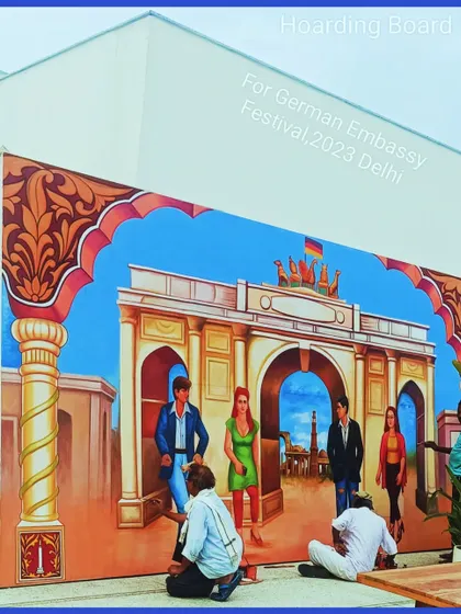 Another angle of the German Embassy mural project, showing the scale and the outdoor setting where the work was done.