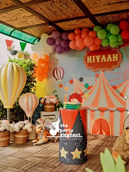 This wide shot of the carnival party shows how I can transform an outdoor space. The setup includes the main backdrop, hot air balloon props, and colorful bunting to create a festive, open-air carnival feel.