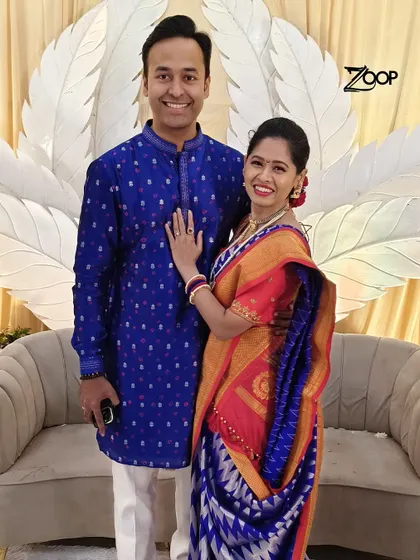 A candid moment with a happy couple. The groom wears my classic blue bandhani-print kurta, a timeless choice for traditional ceremonies.
