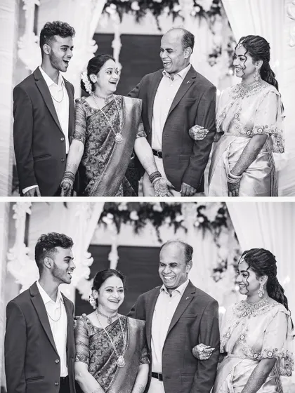 A classic black and white family portrait, capturing the joy and love between the bride and her family.