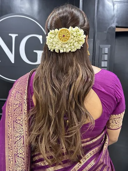 Another beautiful half-up hairstyle, this time with a traditional gajra and a jeweled accessory. This is a perfect blend of modern and traditional for a wedding guest.