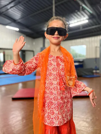 Waving with style and swag. This student is a natural performer, comfortable in front of the camera and full of personality.