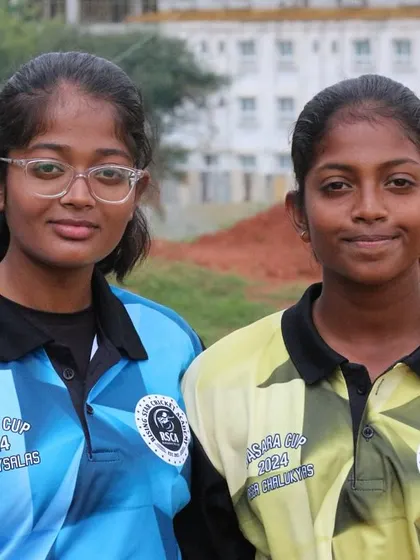 Two young female players from opposing teams, showcasing the competitive yet friendly spirit of our tournaments.