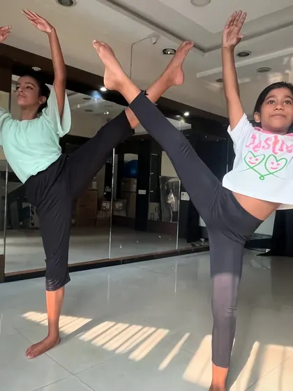 Students practicing splits and leg extensions in my ballet class. These exercises are crucial for developing the flexibility required for ballet.