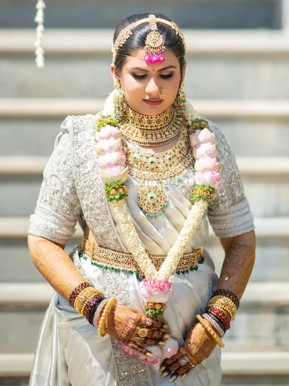 The final, mature stain after 48 hours. The bride's hands are adorned with a deep, reddish-brown color that looks absolutely stunning with her white and gold wedding saree.