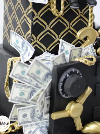 Another angle of the money vault cake, showing the intricate stencil work and gold chains.