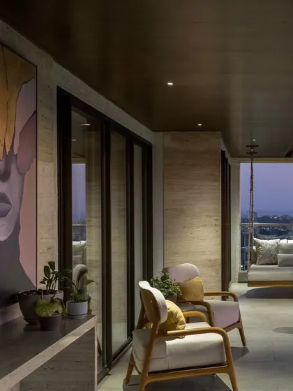 A very large, stunning portrait installed on a balcony in Mumbai. The abstract, leaf-like shapes covering the eyes give it a surreal and mysterious quality.