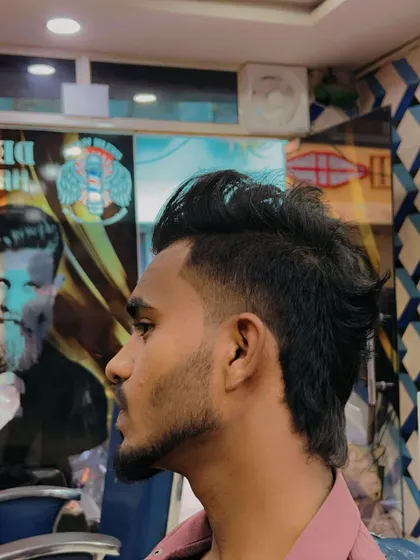 This is a textured, spikier take on the modern mullet. The fade is kept low to create a different kind of silhouette and style.