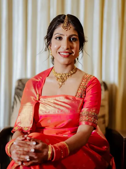 A seated portrait of the bride. Her makeup is soft and elegant.