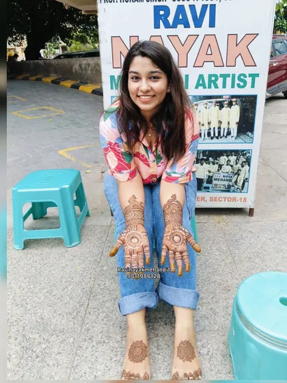 A happy client showing off her full hand and foot mehndi at our stall. We ensure the designs are complementary for a complete and beautiful look.