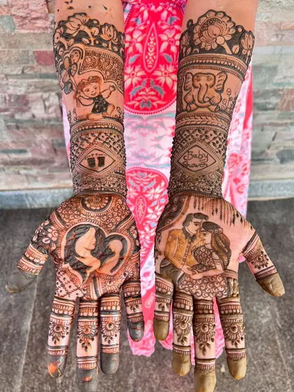 A stunning baby shower mehendi with a rich, dark stain. The design features portraits of the expecting couple and a silhouette of a mother and child.