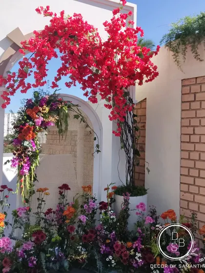 The vibrant red bougainvillea was a key element, chosen by the couple for its personal significance. It added a beautiful burst of color and life to the entire setup.