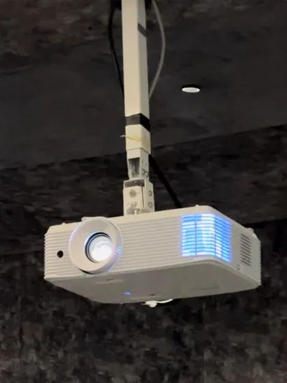 An Optoma projector, ceiling-mounted in a compact home cinema. Even in smaller spaces, I use quality projectors to deliver a large, bright, and sharp image.