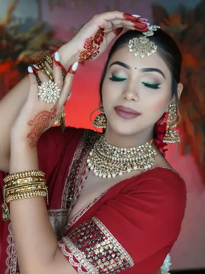 A moment of bridal serenity. The soft focus on the makeup highlights the matte lips and the pop of green on the eyes, a unique twist on a traditional look.