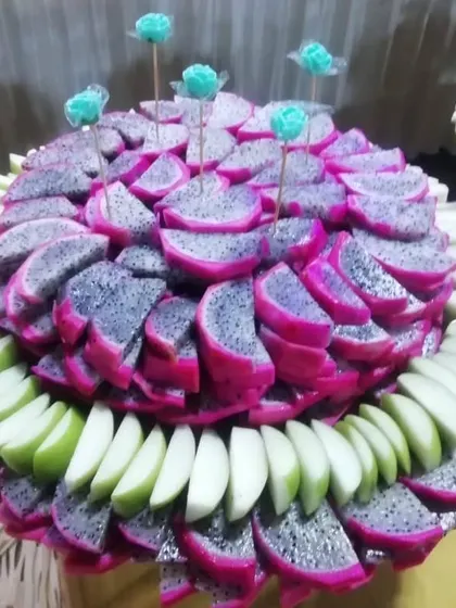 An example of my artistic fruit displays. Here, vibrant pink dragon fruit and green apple slices are meticulously arranged to create a stunning and refreshing centerpiece for the buffet.
