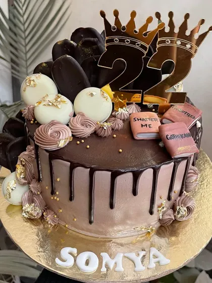 Another view of this book-themed cake, showing the rich chocolate drip and custom name.