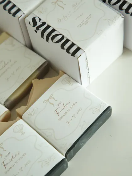 A closer look at the baby shower favors for Tanisha. Each box held two handmade soaps, a wax tablet, and a candle, all with custom labels in soft beige tones to match her invite.
