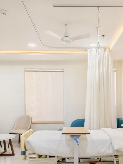 A patient room at Sarvodaya Hospital, designed within the constraints of an existing commercial structure. The room is planned for functionality and comfort, with ample space for medical equipment and a window for natural light, aiding in recovery.