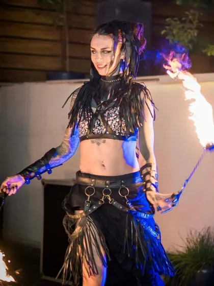 Our artist performs with fire poi, showcasing the flowing tails of flame that create beautiful patterns in the dark. This is a classic and mesmerizing fire dancing tool.