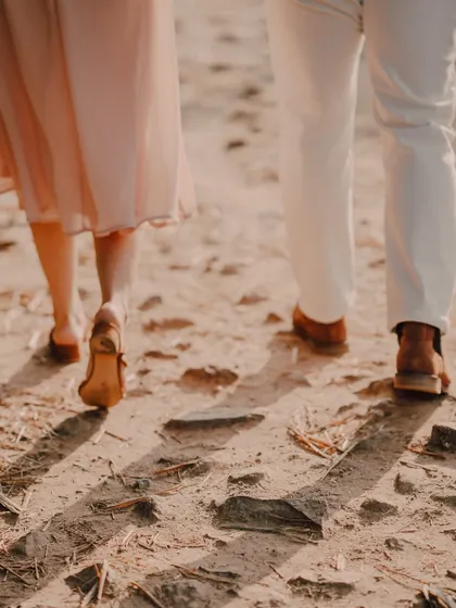 A close-up shot of a couple's feet as they walk on a rustic path. This detail-oriented photo adds a lovely narrative touch to their pre-wedding album, symbolizing their journey.