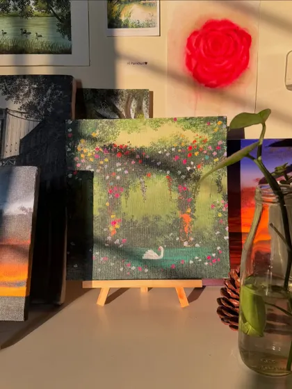 My swan painting on a small easel in my studio, with the sunlight hitting it just right. It looks so peaceful among my other creations.