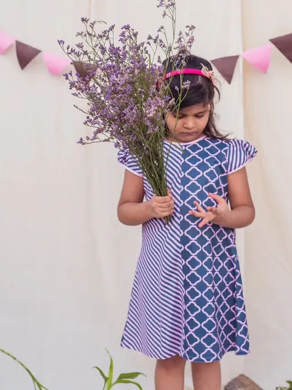 A different angle of this stylish printed dress, perfect for a girl with a unique sense of fashion.