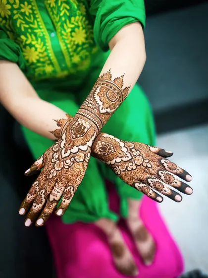 A stunning bridal design with bold, prominent motifs that stand out. The dark, mature stain makes every detail of the intricate patterns visible.