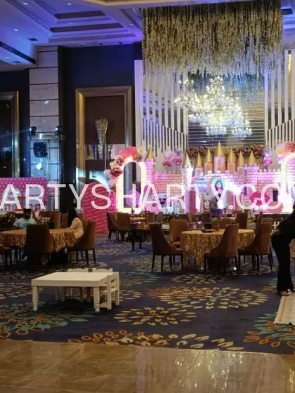 A wide view of a princess-themed party setup, showing the main stage, guest seating arrangements, and dedicated kids' tables, demonstrating our full-venue planning.