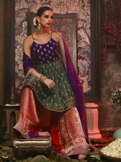 A vibrant and festive look for Soho Begum, featuring a model in a colorful sharara set with rich textures and patterns.