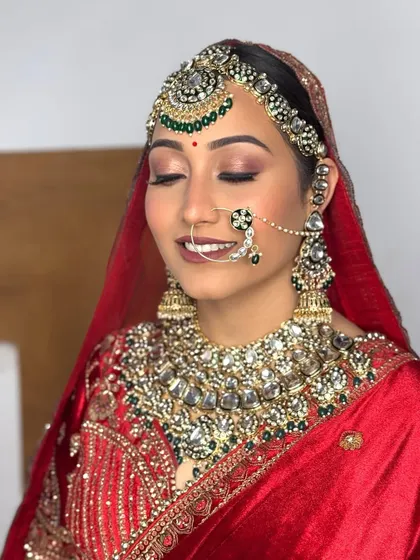 A close-up of a luxurious bridal look. The eye makeup is soft yet defined, paired with a bold lip and flawless skin, creating a perfect balance for a royal aesthetic.