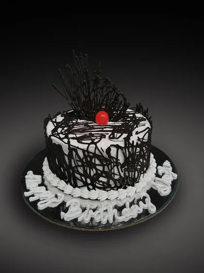 A classic Black Forest cake. This design features whipped cream, chocolate shavings, and a bright red cherry on top for that iconic look.