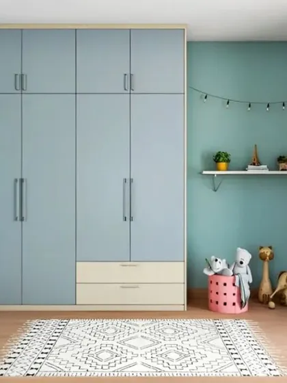 A simple and clean wardrobe design for a child's room in a lovely pastel blue. The loft storage on top is perfect for storing items that are not used daily, keeping the room clutter-free.