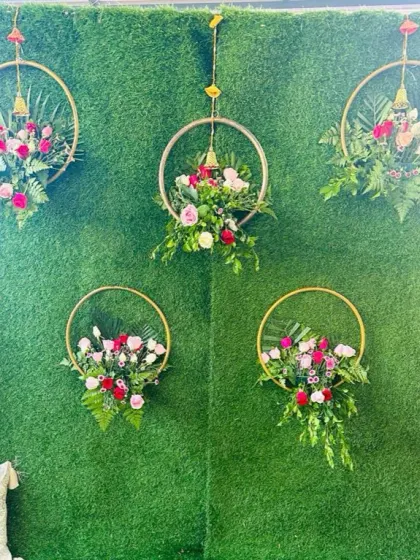 Another view of the floral hoops against the green wall, a great option for simple and modern Mehendi or Haldi decor.