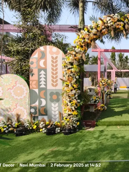A modern and artistic entrance for a Haldi ceremony. The pastel-colored panels with geometric patterns and a beautiful floral arch create a unique and stylish welcome for guests.