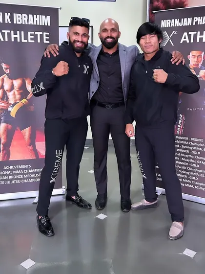 It is showtime. Standing with two of my sponsored athletes. I support my fighters in and out of the cage.