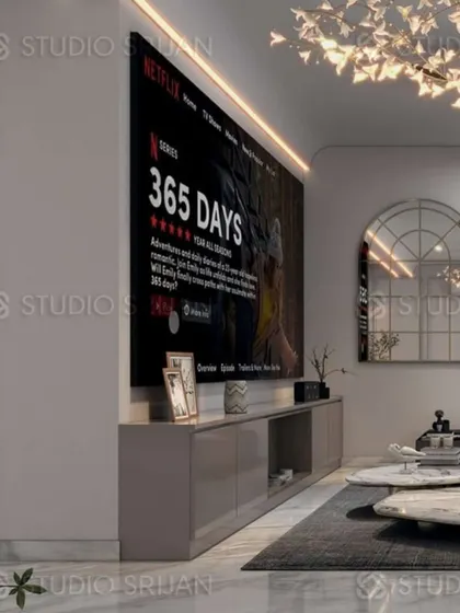 This living area in Mansarovar Garden is designed for entertainment, featuring a large projector screen for a cinematic experience.