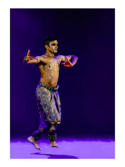 A mid-air moment from a solo performance, capturing the energy and dynamism of the dance.