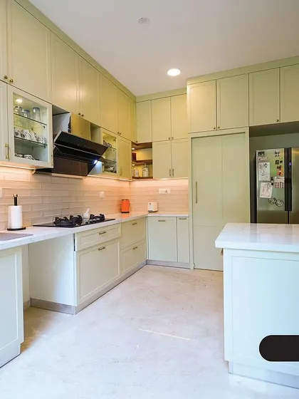 This pastel green kitchen offers a soft, refreshing take on modern design. The shaker-style cabinets provide ample storage, while the white island and countertops keep the space feeling bright and open.