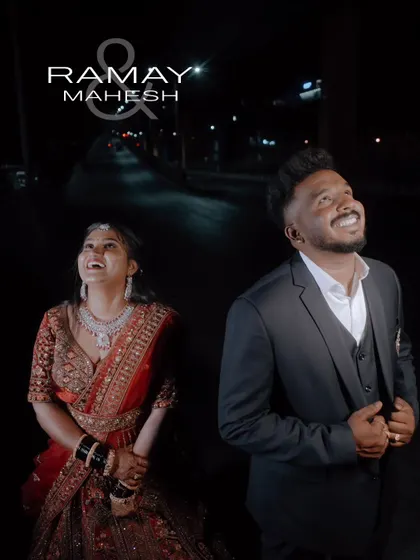 A happy, candid shot of the couple looking up at the night sky during their outdoor reception shoot.