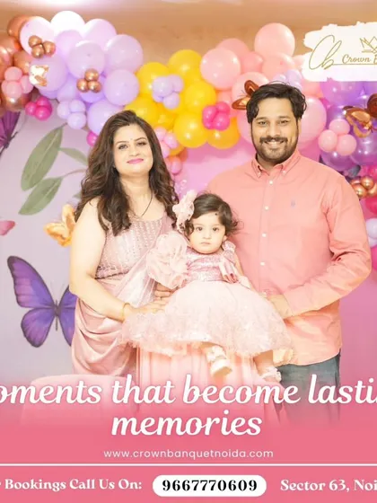 A picture-perfect family moment at a butterfly-themed birthday. The soft pink and purple balloon decor creates a beautiful and gentle atmosphere for celebrating your little one.