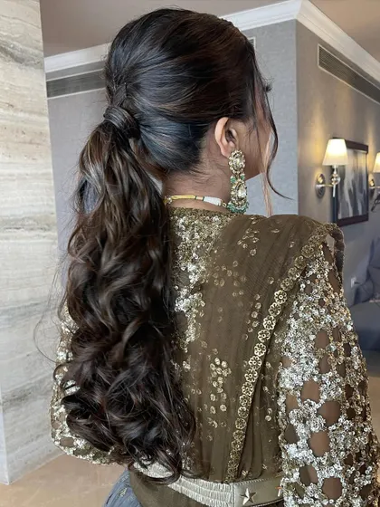 The groom's sister looks stunning with her messy ponytail, a perfect choice for a wedding guest.