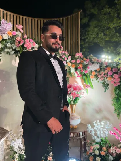A candid shot from a beautiful wedding reception. Dressed in a classic tuxedo, I'm ready to perform or get the after-party started on the dance floor.