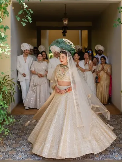 The bride's stunning twirl as she reveals her wedding look to her family. A moment of pure happiness and excitement at Sula Vineyards.