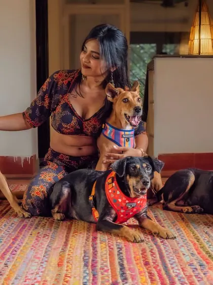 A stunning portrait of a woman with her four indie dogs, showcasing the beauty and love of a multi-pet household.