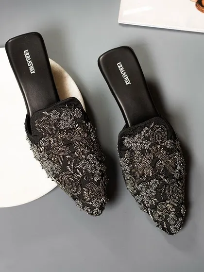 Step into something beautiful. These black embroidered mules are all about subtle elegance and a little shimmer, perfect for an evening out.