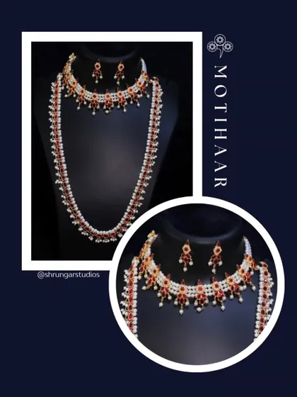 A classic Motihaar set with red stones and pearls, including a choker and a matching long necklace.