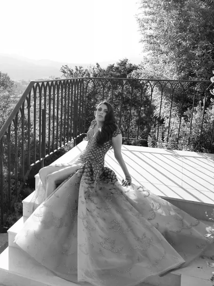 A black and white shot that highlights the texture and silhouette of the Versace gown. Sometimes, stripping away color reveals the true artistry of the design.